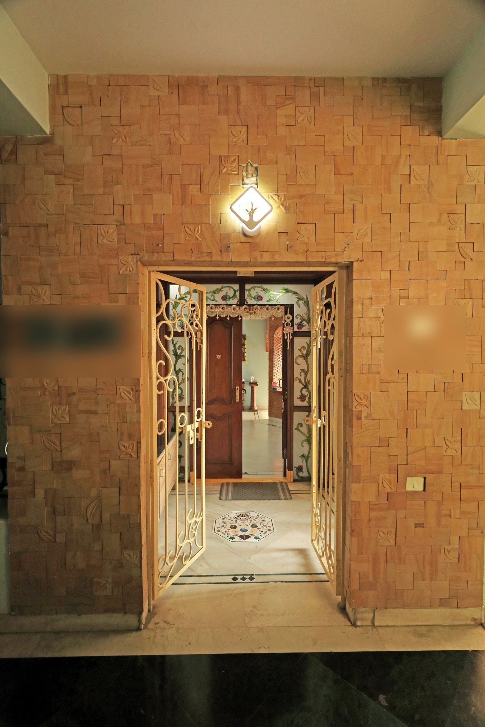 Entrance doorway at the building, with the ornate wooden door open into the home