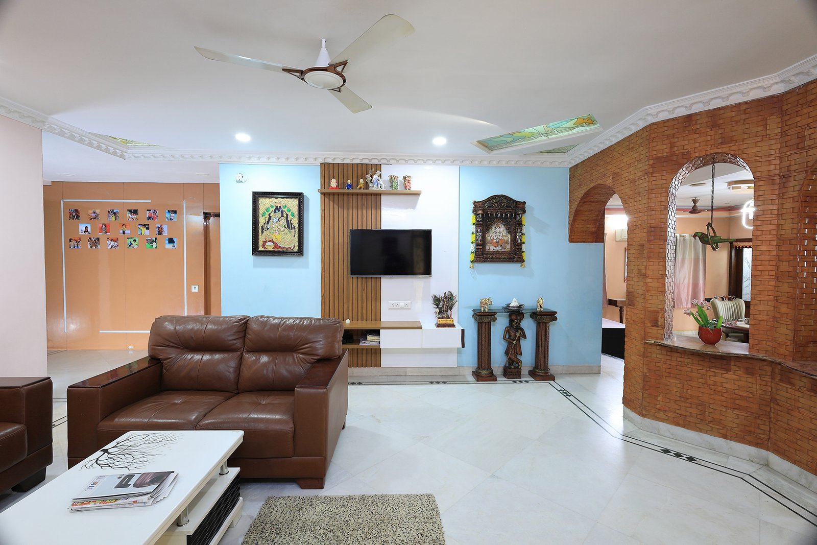 TV wall with decorative archway and family photo display