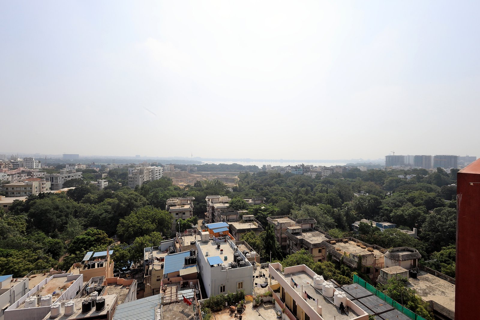 View from the terrace over the lake, greenery, and city skyline